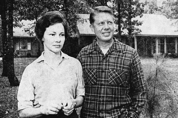 Portrait of Jimmy and Rosalynn Carter in their middle years standing in the garden of their Plains, Georgia family home